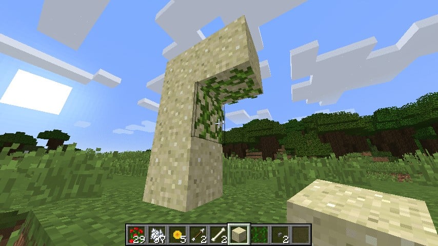 You can make hanging sand.  Simply put vines on an adjacent block, and put the sand on top of this.